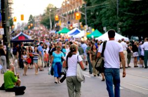 Summer street fair with a large crowd of people