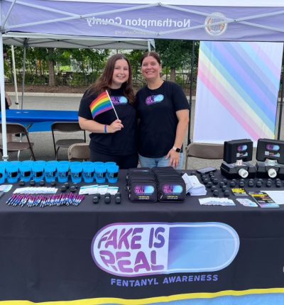 Fake Is real table at Pride event